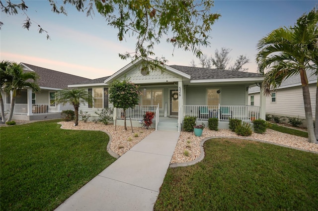 ranch-style house with a yard and a porch