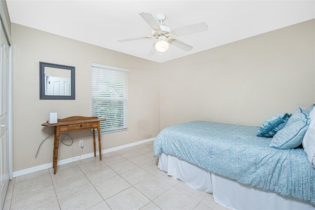 bedroom featuring ceiling fan, tile patterned flooring, and a closet