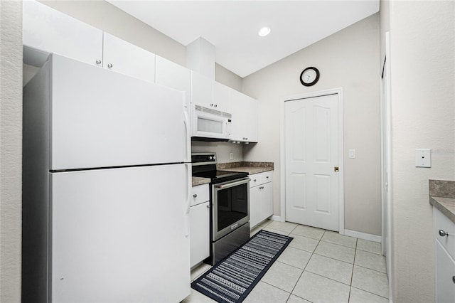 kitchen featuring light tile patterned flooring, white cabinetry, and white appliances