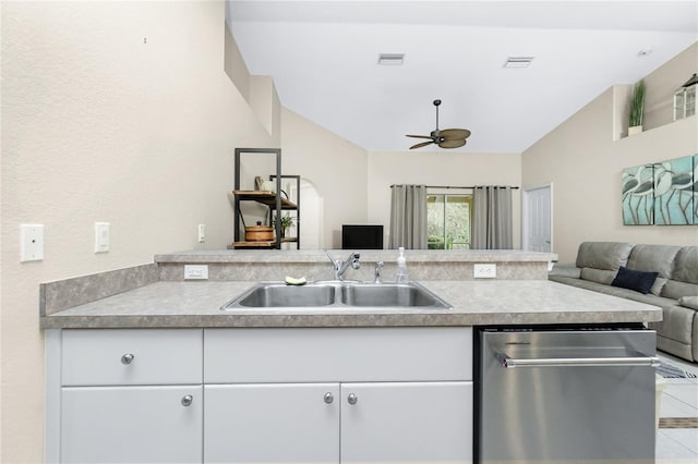 kitchen featuring dishwasher, white cabinetry, sink, vaulted ceiling, and ceiling fan