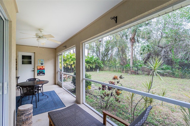 sunroom featuring ceiling fan