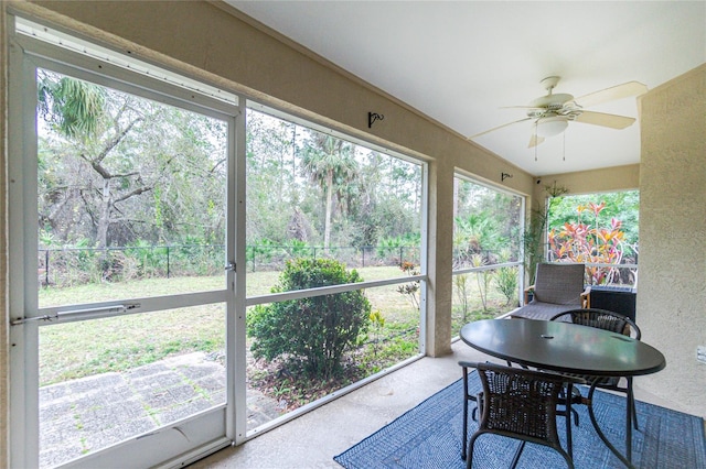 sunroom / solarium featuring ceiling fan