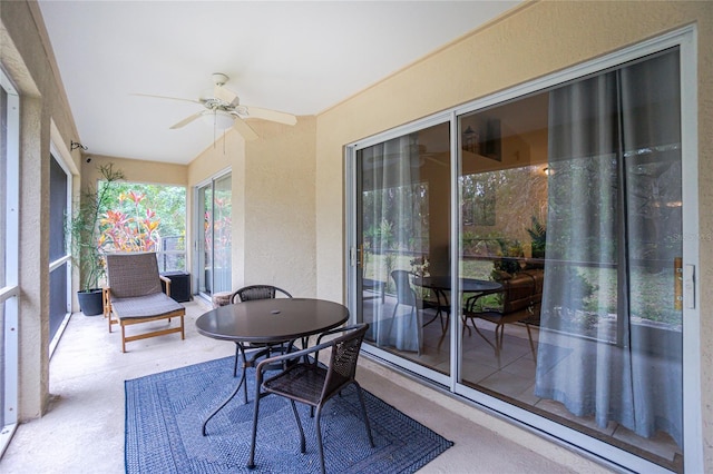 sunroom / solarium featuring ceiling fan