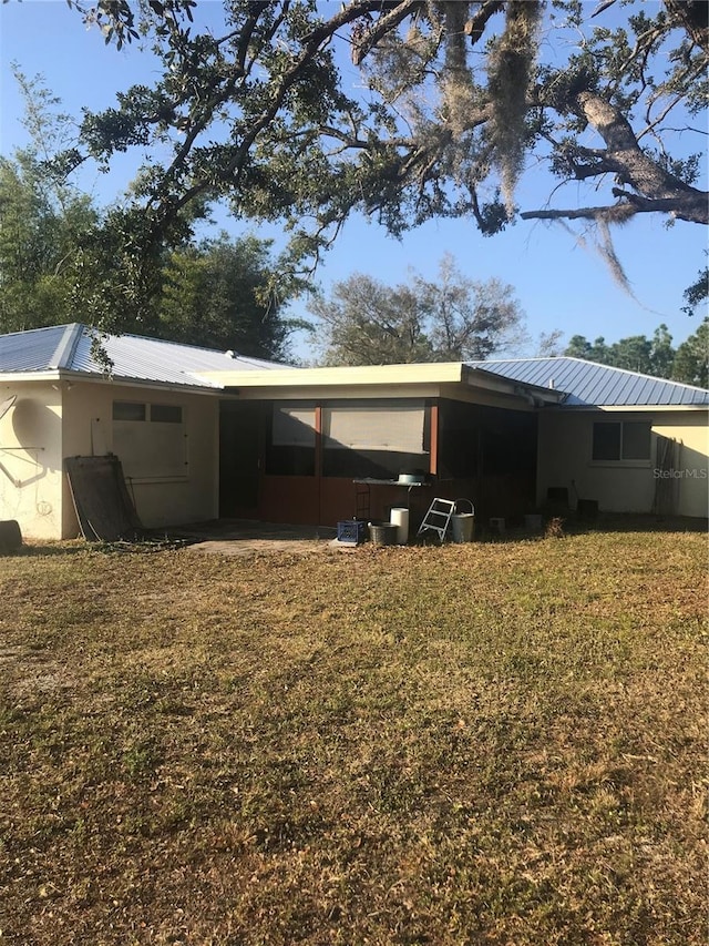 back of house with a yard