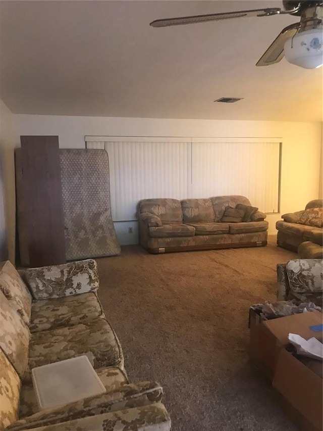 carpeted living room featuring ceiling fan