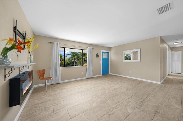 unfurnished living room with light tile patterned floors