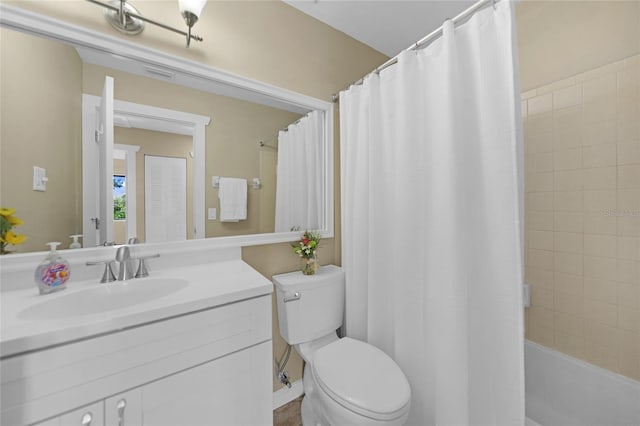 full bathroom with vanity, shower / bath combo, and toilet