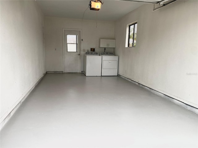 garage featuring a garage door opener and washer and clothes dryer