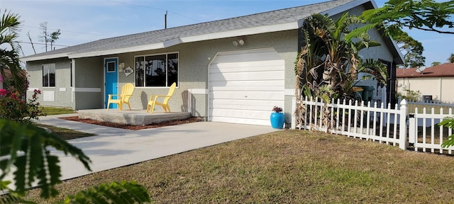 back of house with a yard and a garage