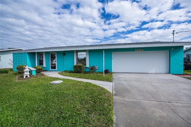 ranch-style home with a garage and a front lawn