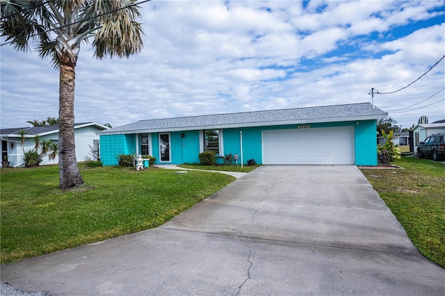 ranch-style home with a garage and a front lawn