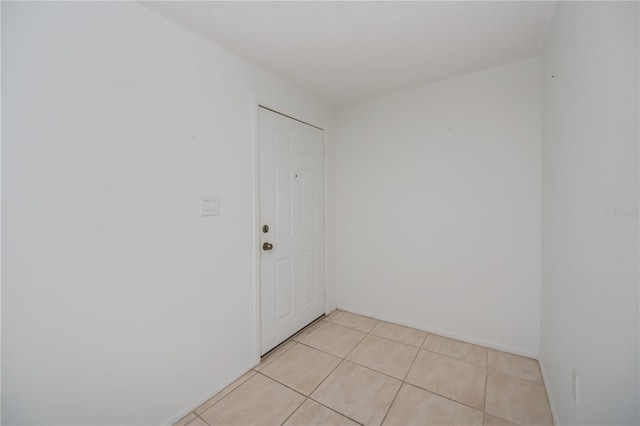 unfurnished room featuring light tile patterned floors