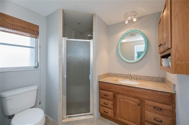 bathroom featuring toilet, vanity, tile patterned floors, a textured ceiling, and an enclosed shower