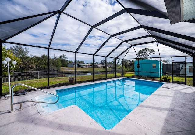 view of pool featuring a patio area, a lanai, a water view, and a shed