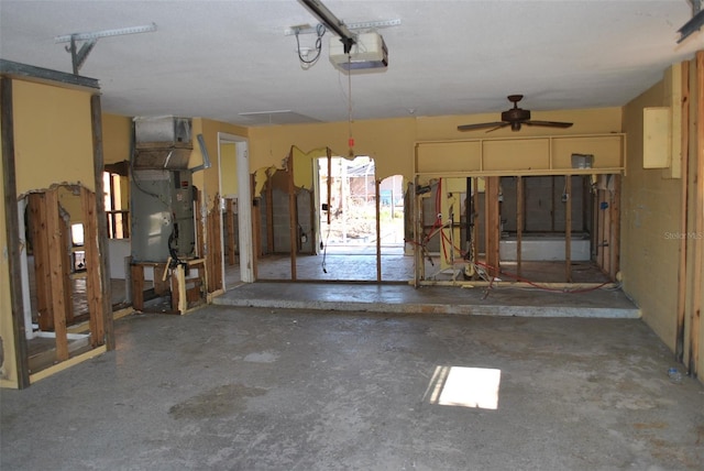 garage with a garage door opener, heating unit, and ceiling fan