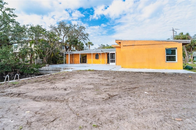 back of property with stucco siding