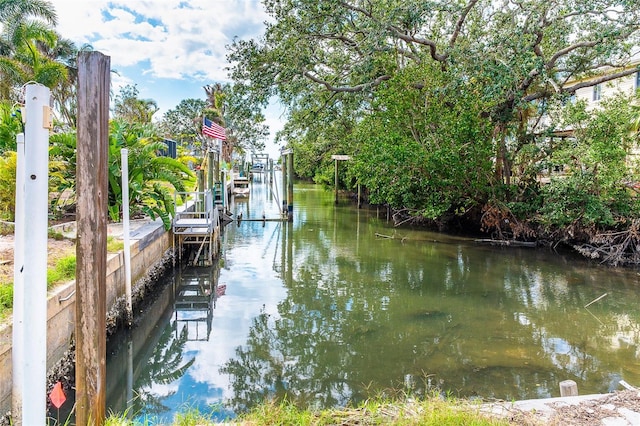 dock area with a water view and boat lift