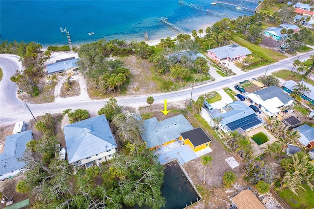 drone / aerial view with a water view and a residential view