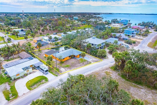 birds eye view of property with a water view and a residential view