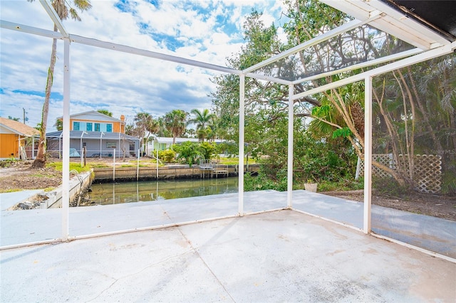 unfurnished sunroom with a water view