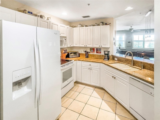 kitchen featuring white appliances, white cabinetry, sink, light stone counters, and light tile patterned floors