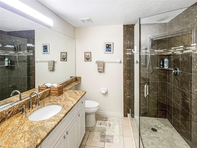 bathroom with a textured ceiling, tile patterned floors, vanity, toilet, and a shower with shower door