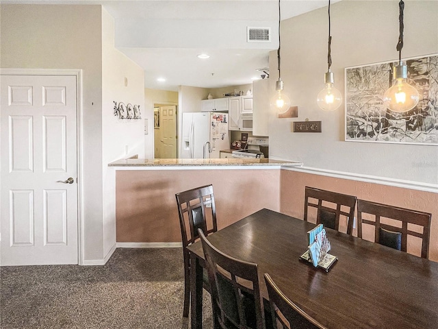 view of carpeted dining space