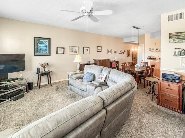 living room with ceiling fan and carpet flooring