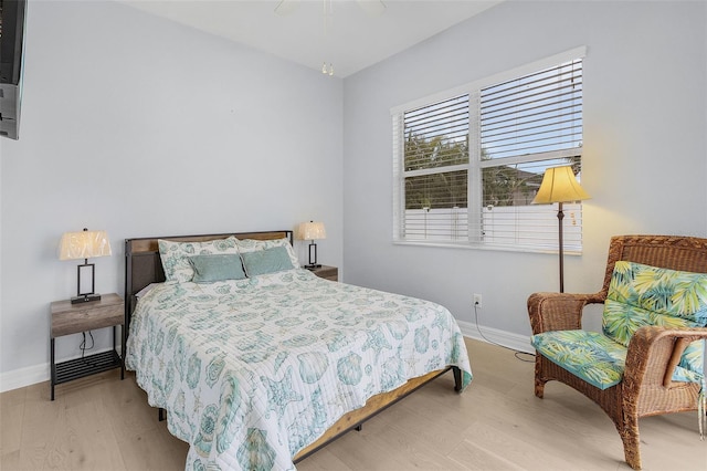 bedroom with ceiling fan and light wood-type flooring