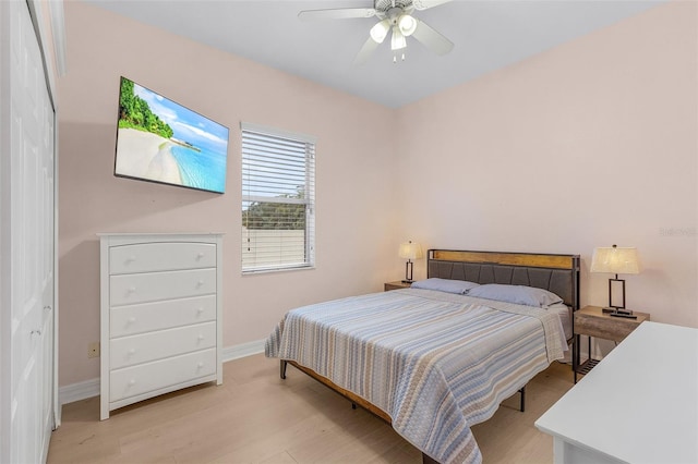 bedroom with ceiling fan, a closet, and light wood-type flooring