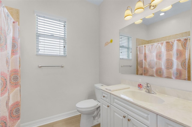 bathroom featuring toilet, vanity, and a shower with shower curtain