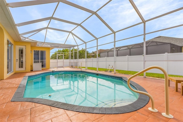 view of swimming pool featuring a patio area and a lanai