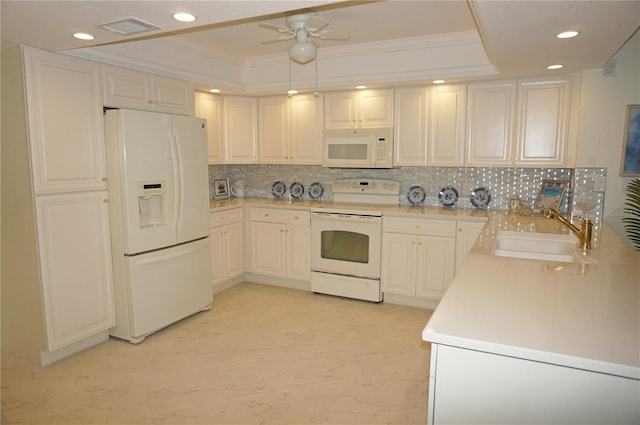 kitchen with ceiling fan, a raised ceiling, tasteful backsplash, white appliances, and sink