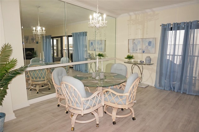 dining room with an inviting chandelier, a fireplace, crown molding, and light hardwood / wood-style floors