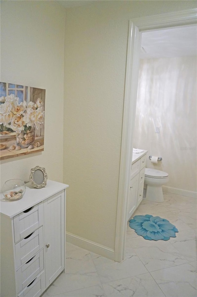 bathroom featuring toilet and vanity