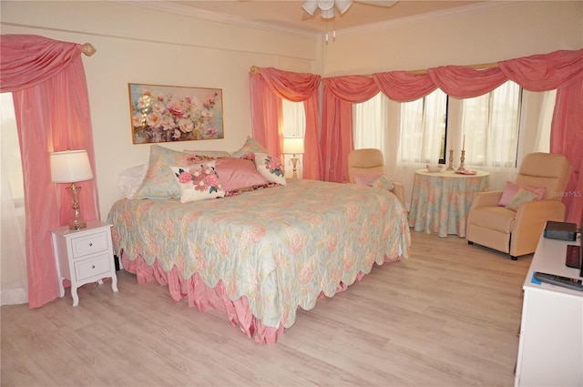 bedroom featuring ceiling fan, crown molding, and hardwood / wood-style floors