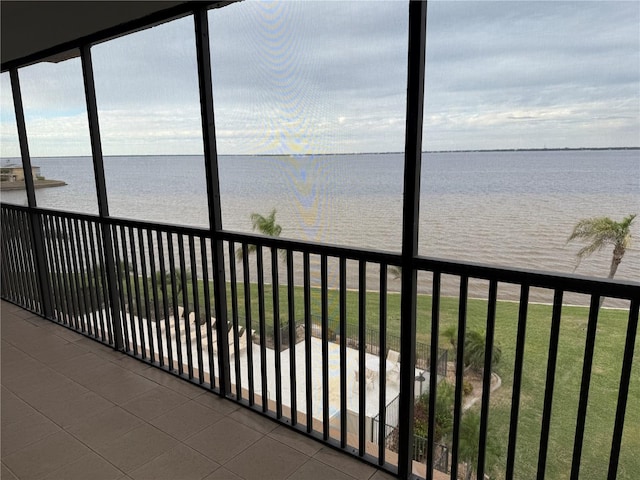 unfurnished sunroom with a water view