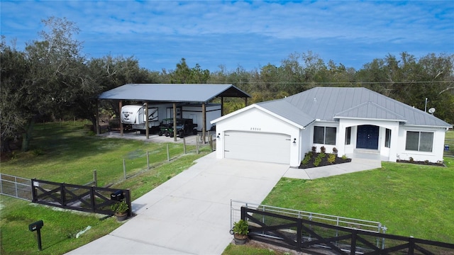 29350 Goodhue St, Punta Gorda, FL 33982 - view of front of house featuring a garage, a front yard, and a carport