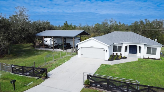 view of front of house featuring a garage, a front yard, and a carport