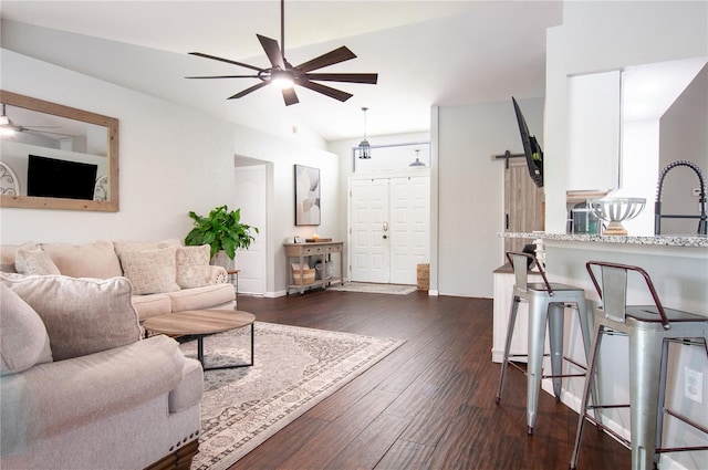 living room with ceiling fan, dark wood-type flooring, and sink