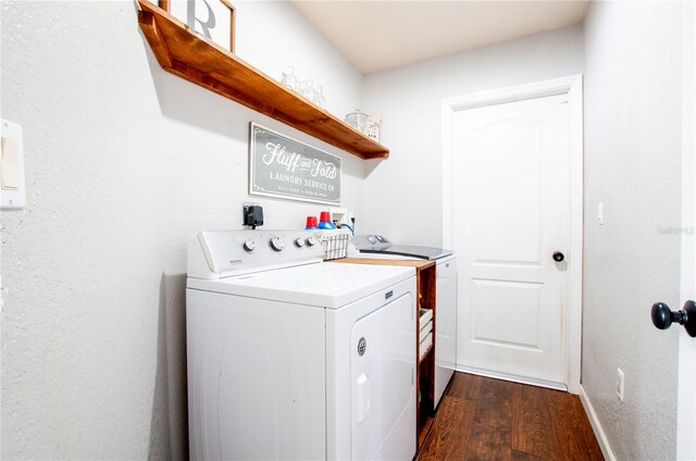 laundry area with washer and dryer and dark hardwood / wood-style floors