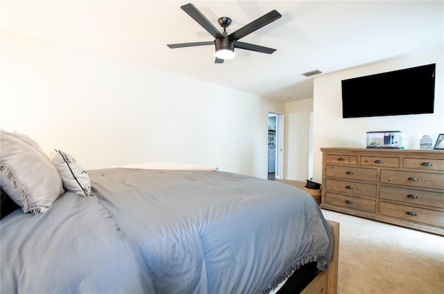 bedroom with ceiling fan and light colored carpet