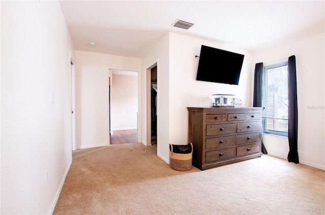 unfurnished bedroom with light carpet and a closet