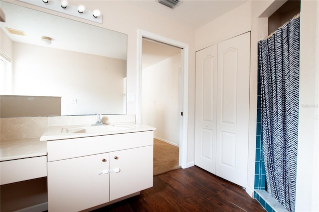 bathroom with hardwood / wood-style floors, vanity, and a shower with shower curtain