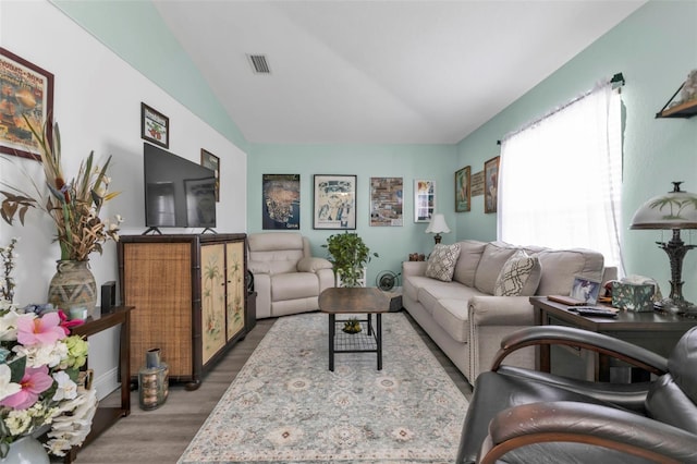 living room with wood-type flooring and vaulted ceiling