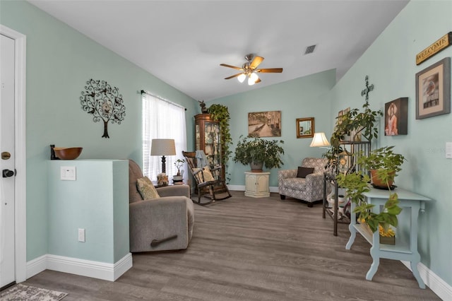 living room with ceiling fan, hardwood / wood-style floors, and vaulted ceiling