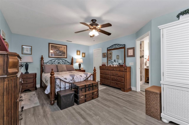 bedroom featuring ceiling fan, ensuite bathroom, and light hardwood / wood-style floors