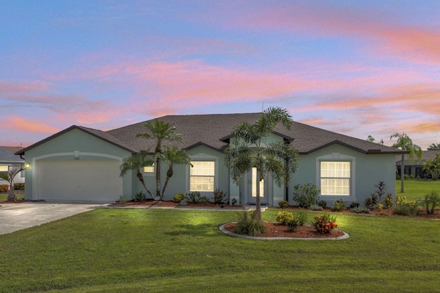 ranch-style home with a yard and a garage