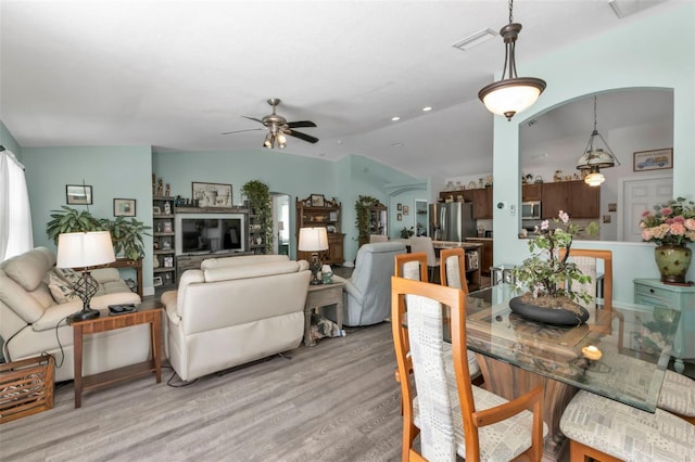 dining area featuring light wood-type flooring, ceiling fan, and lofted ceiling