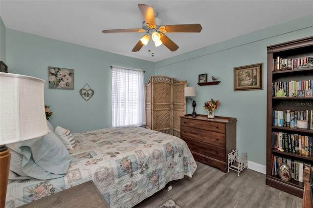 bedroom with ceiling fan and hardwood / wood-style flooring